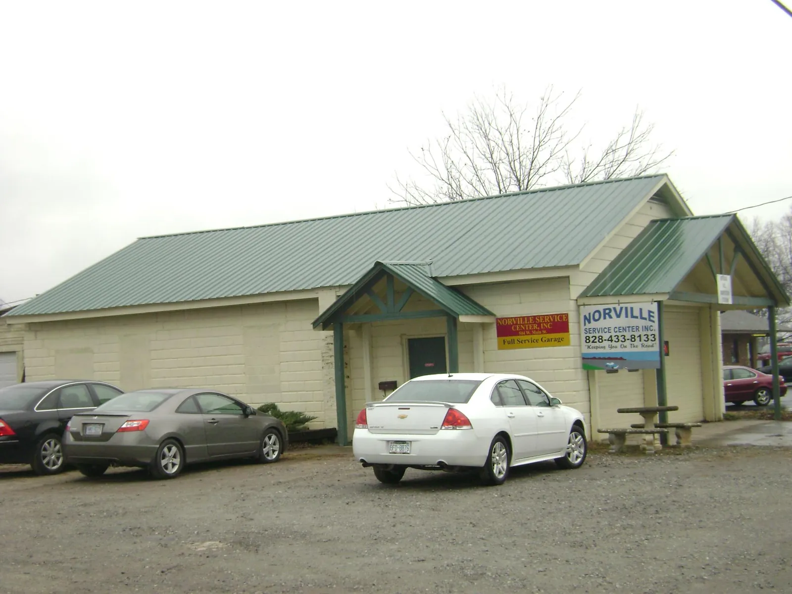 Green metal roof on a service garage with a covered entry in Hinsdale