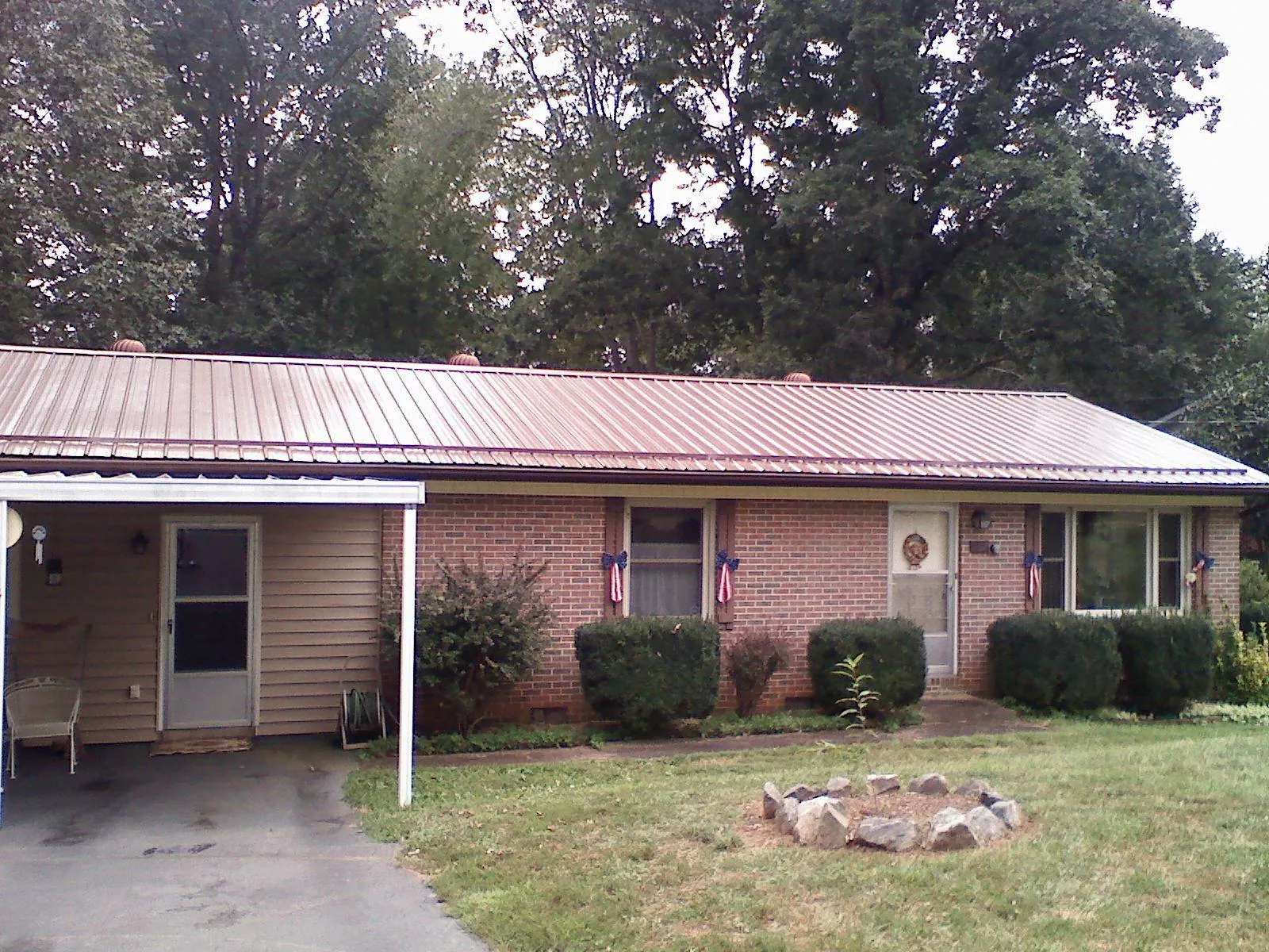 Bronze metal roof and carport on a brick ranch home — Roof Repair work by our crew in Hinsdale